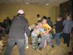 Boys playing in the straw at the Kensington Church Bon Fire